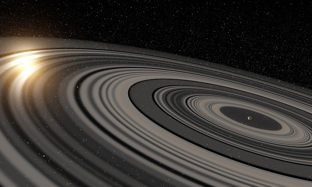 Rappresentazione artistica del sistema di anelli extrasolari che circonda il giovane esopianeta gigante o nana bruna J1407b. Gli anelli sono rappresentati mentre eclissano la giovane stella simile al sole J1407 e come sarebbero apparsi all'inizio del 2007. Credit: Ron Miller