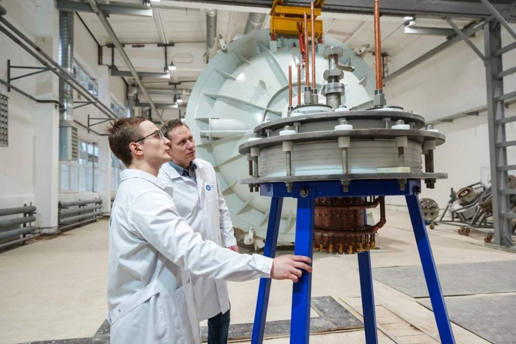 Scienziati di Rosatom con il prototipo del motore al plasma destinato ai voli interplanetari. Credito. Rosatom